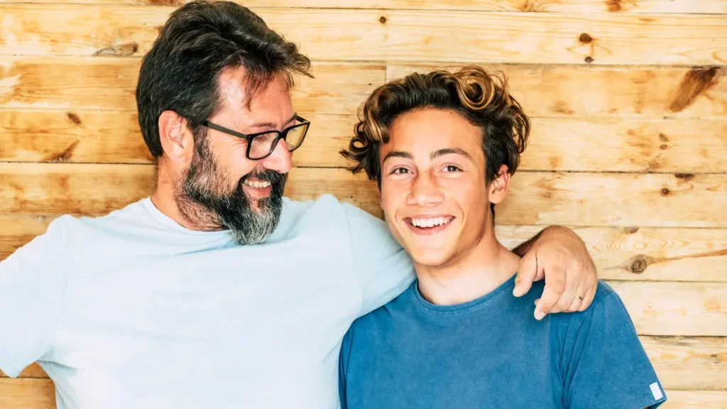Dad looking and smiling at son.