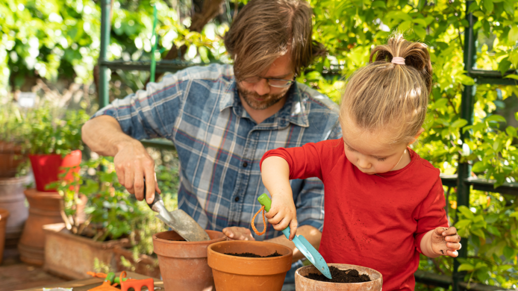 Man planting with a little girl.